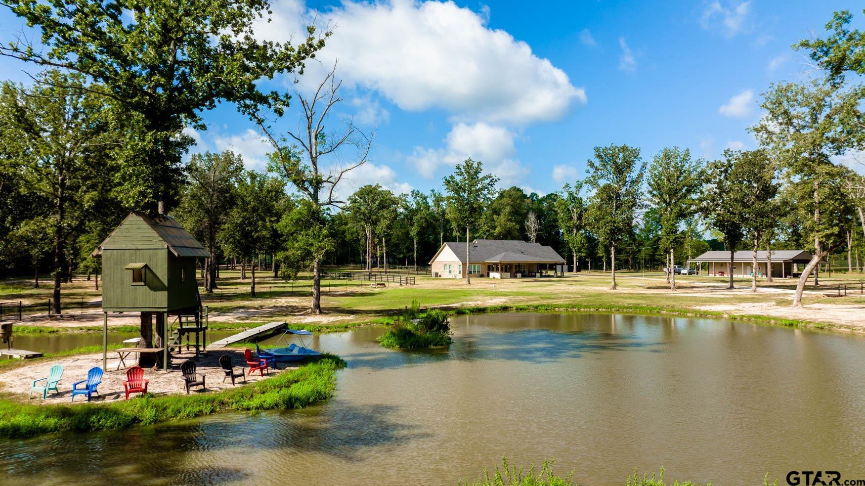 343 Driskell Bridge Road Harleton, TX 75651 - Photo 36 of 42 a view of swimming pool with outdoor seating and lake view