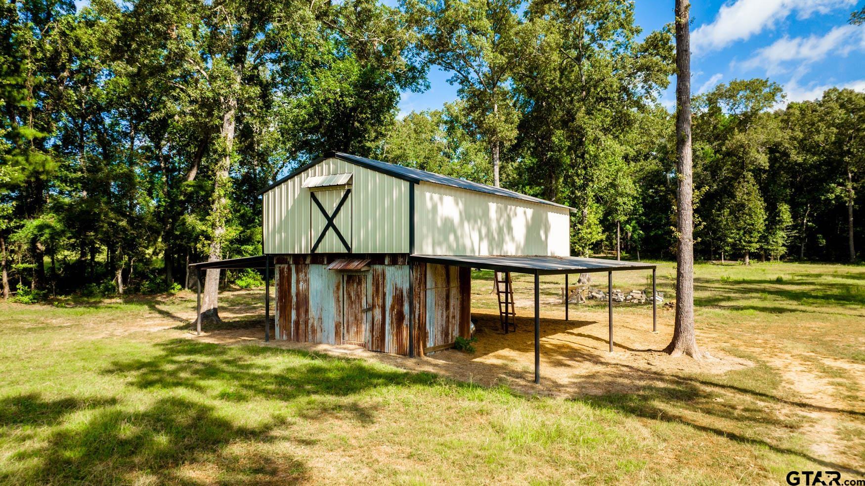 343 Driskell Bridge Road Harleton, TX 75651 - Photo 38 of 42 a house with trees in the background
