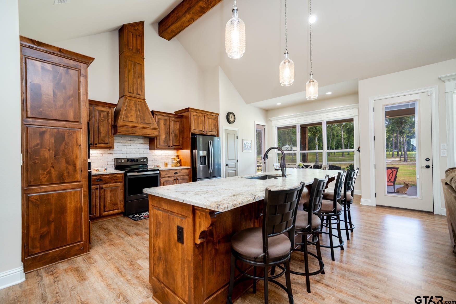 343 Driskell Bridge Road Harleton, TX 75651 - Photo 6 of 42 a kitchen with stainless steel appliances granite countertop table chairs and wooden floor