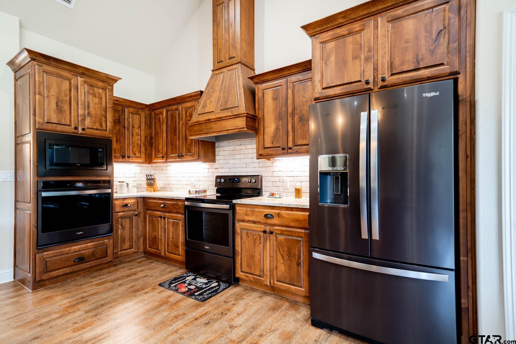 343 Driskell Bridge Road Harleton, TX 75651 - Photo 8 of 42 a kitchen with stainless steel appliances granite countertop a refrigerator stove and sink
