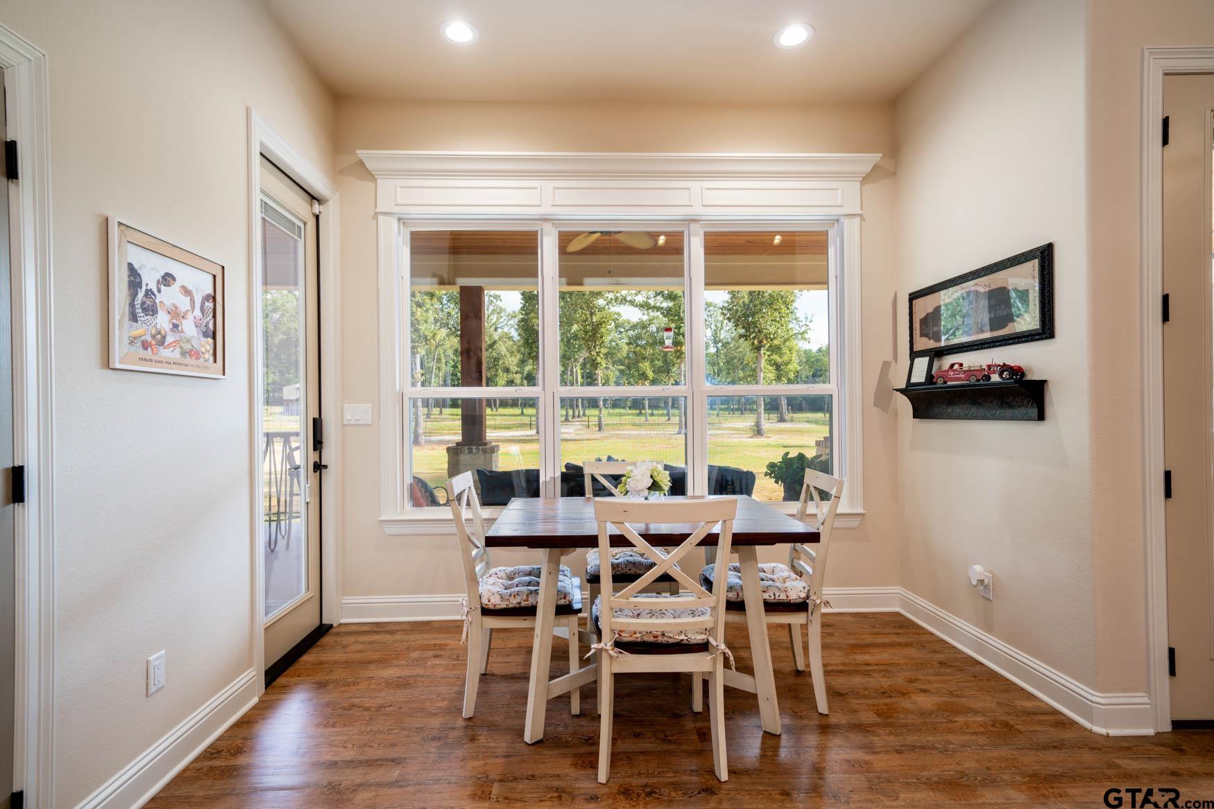 343 Driskell Bridge Road Harleton, TX 75651 - Photo 10 of 42 a view of a dining room with furniture large window and wooden floor