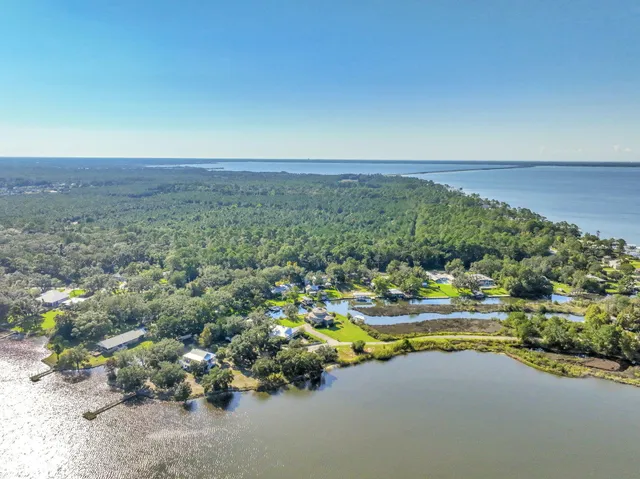 an aerial view of a houses with a lake view
