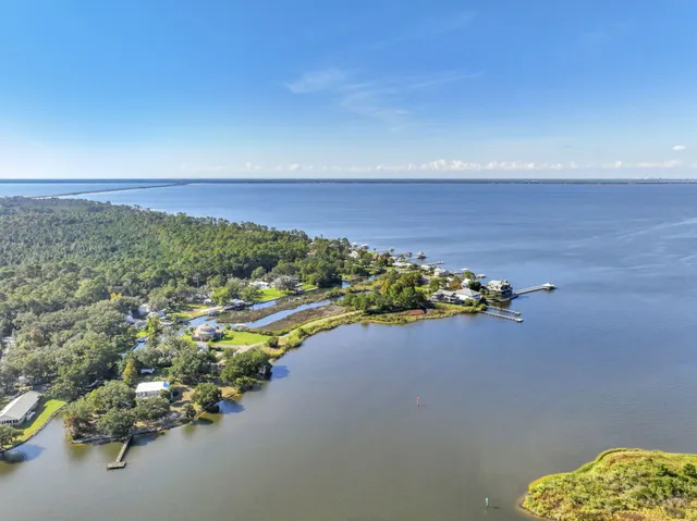 an aerial view of a houses with a lake view