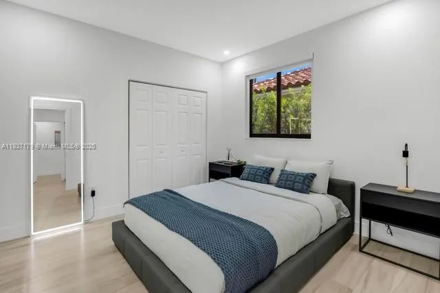 a bedroom with a bed and a window