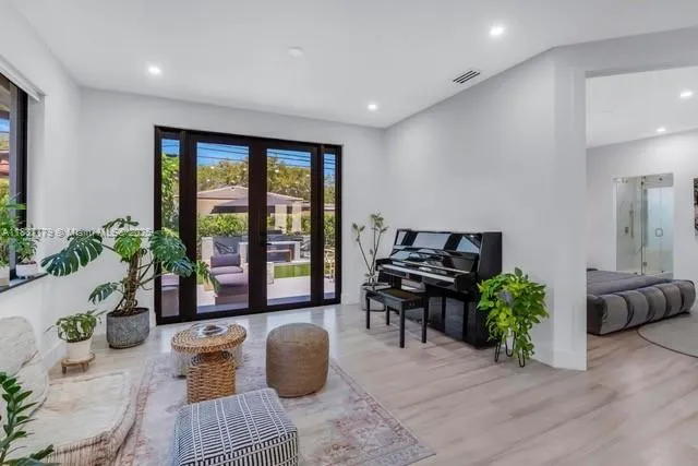 a living room with furniture and a potted plant
