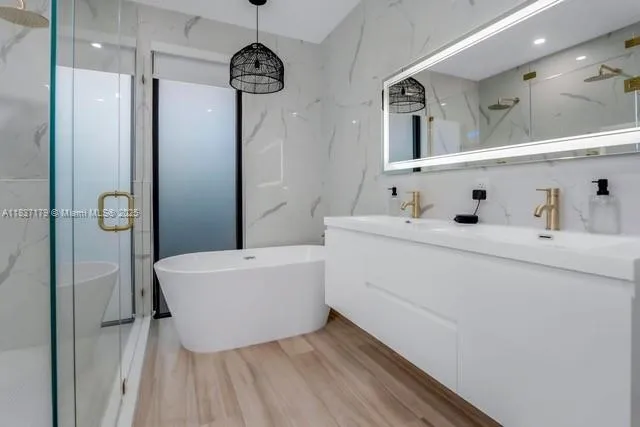 a bathroom with a tub sink and mirror