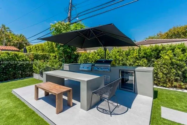 a view of a chairs and table under an umbrella