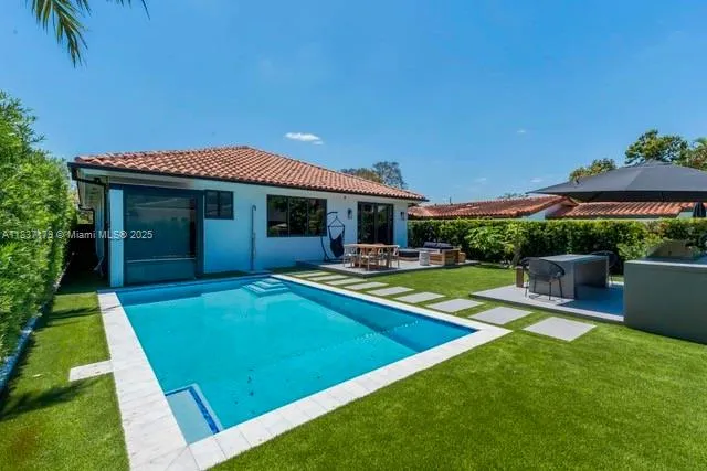 a view of a house with a backyard porch and sitting area