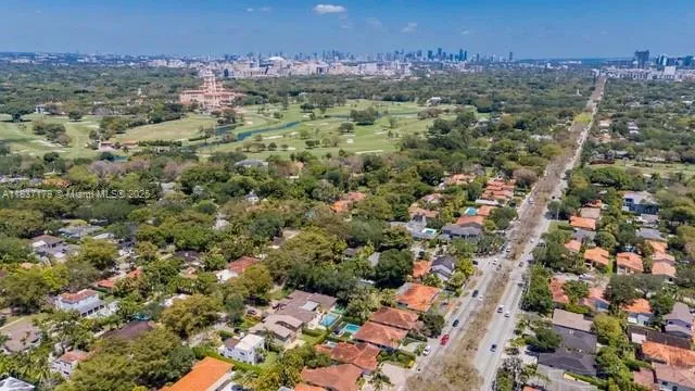 an aerial view of a residential houses with city view