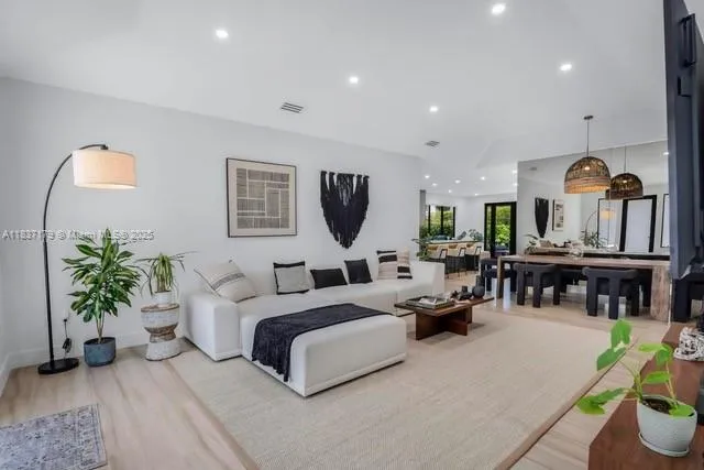 a living room with furniture and a potted plant