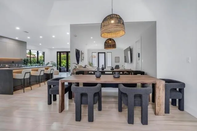 a kitchen with stainless steel appliances a dining table and chairs