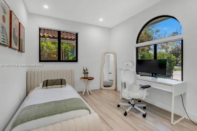 a bedroom with a bed and a flat screen tv