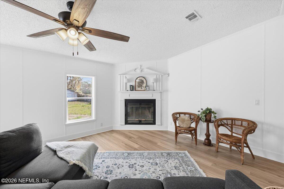 345 Jones Road Jacksonville, FL 32220 - Photo 12 of 32 a living room with furniture and a fireplace