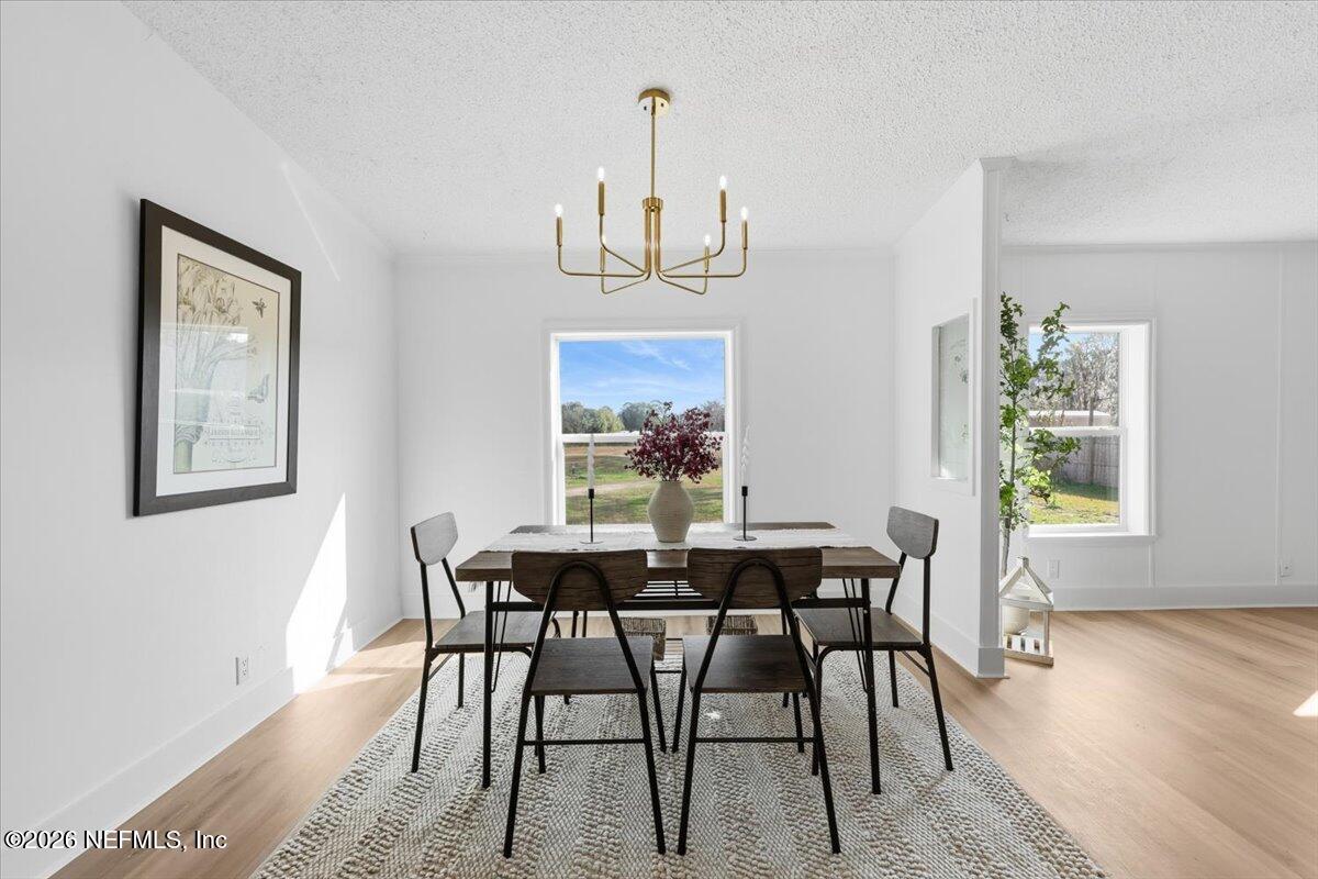 345 Jones Road Jacksonville, FL 32220 - Photo 15 of 32 a view of a dining room with furniture window and wooden floor