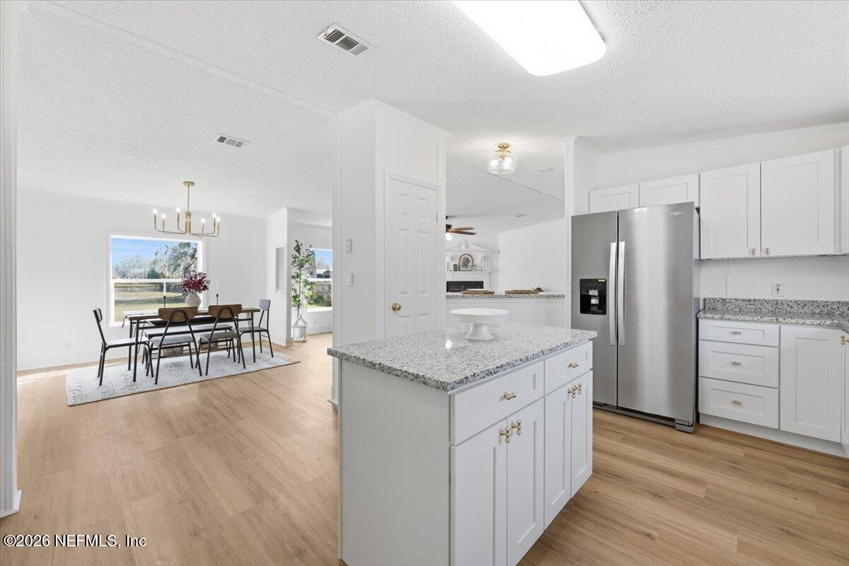 345 Jones Road Jacksonville, FL 32220 - Photo 19 of 32 a kitchen with white cabinets and stainless steel appliances