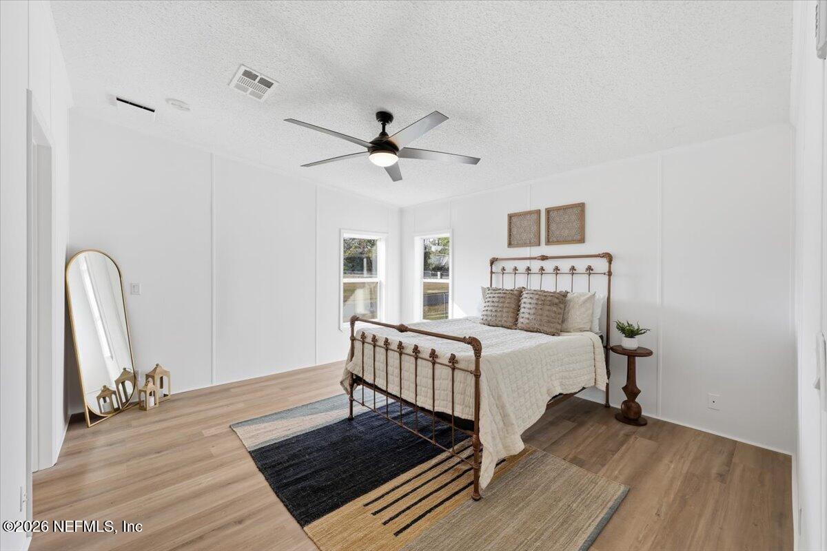 345 Jones Road Jacksonville, FL 32220 - Photo 20 of 32 a bedroom with a bed and a chandelier