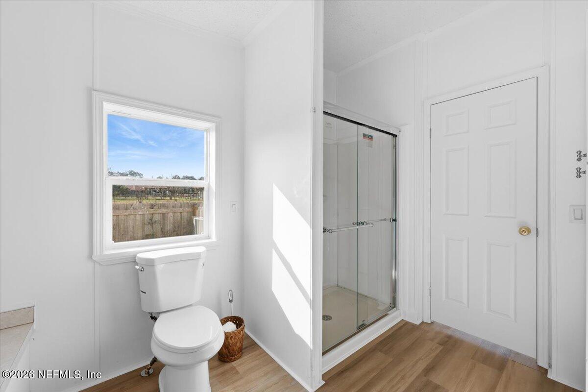 345 Jones Road Jacksonville, FL 32220 - Photo 26 of 32 a bathroom with a toilet sink and a mirror