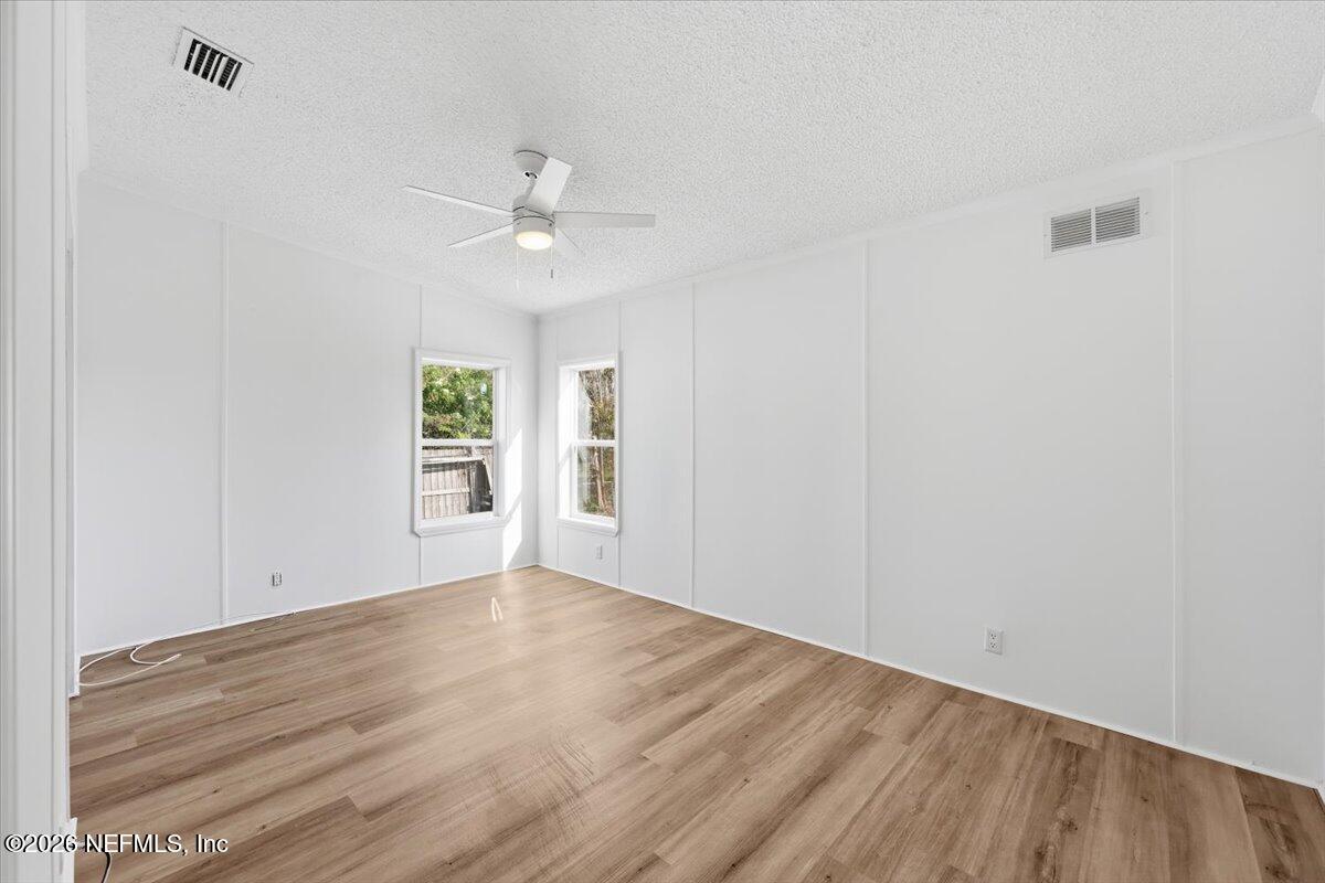 345 Jones Road Jacksonville, FL 32220 - Photo 30 of 32 wooden floor in an empty room with a window