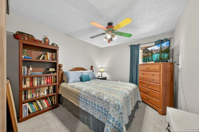 a bedroom with a bed and a book shelf