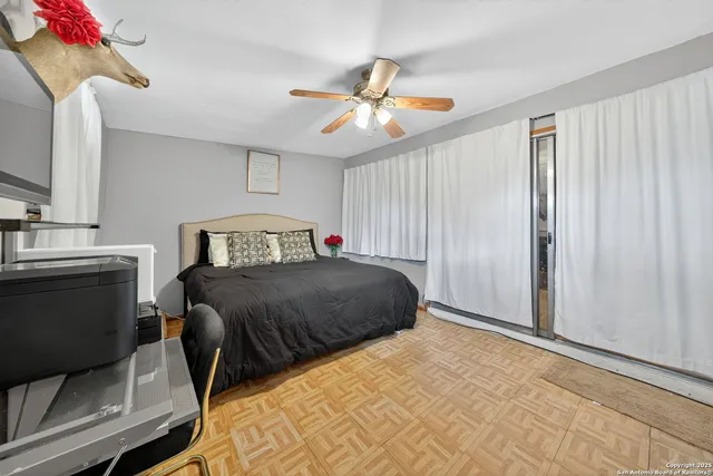 a bedroom with a bed and a chandelier
