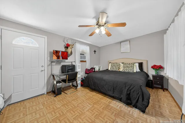 a bedroom with a bed and a chandelier