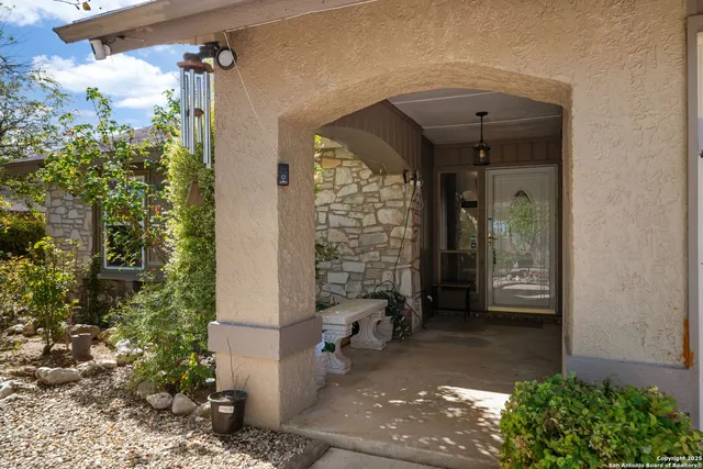 a view of a front door of the house and trees