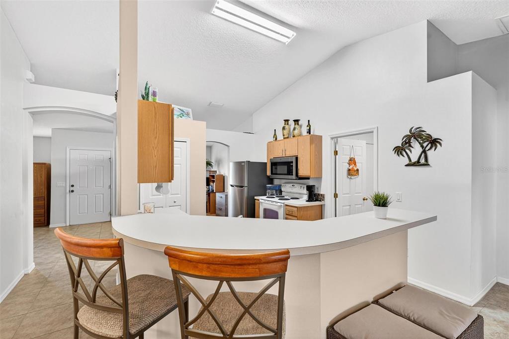 3859 Southwest 109th Lane Ocala, FL 34476 - Photo 19 of 55 a dining room with furniture a large window and a refrigerator