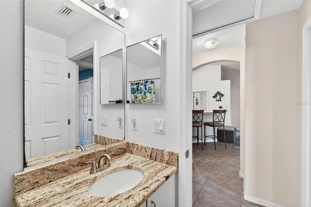 3859 Southwest 109th Lane Ocala, FL 34476 - Photo 28 of 55 a en suite bathroom with a granite countertop sink and a mirror