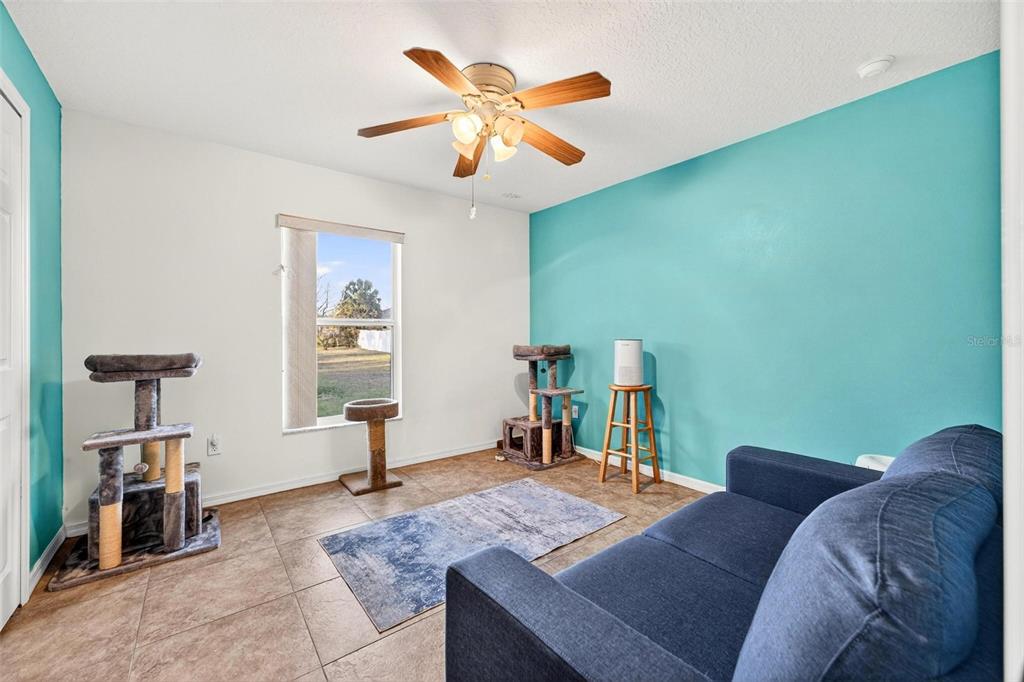 3859 Southwest 109th Lane Ocala, FL 34476 - Photo 31 of 55 a living room with furniture and a chandelier