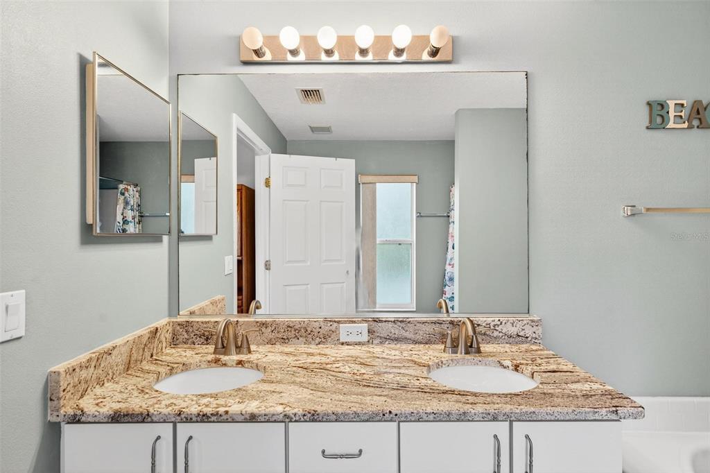 3859 Southwest 109th Lane Ocala, FL 34476 - Photo 38 of 55 a bathroom with a granite countertop sink and a mirror