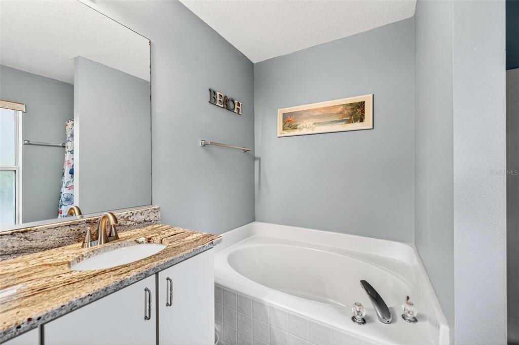 3859 Southwest 109th Lane Ocala, FL 34476 - Photo 39 of 55 a bathroom with a granite countertop sink and a mirror