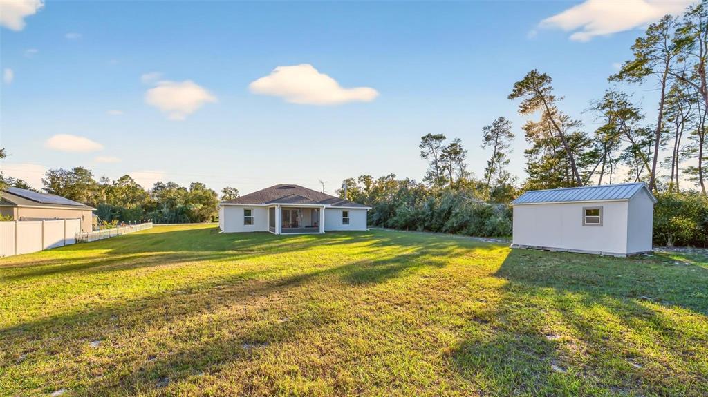 3859 Southwest 109th Lane Ocala, FL 34476 - Photo 48 of 55 a view of a house with a yard and a large pool