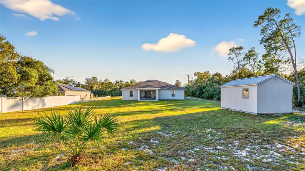 3859 Southwest 109th Lane Ocala, FL 34476 - Photo 49 of 55 a view of a house with pool and a yard