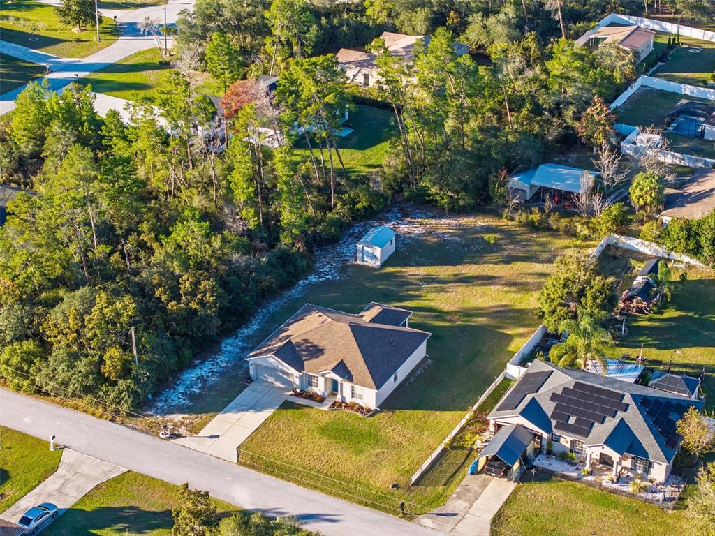 3859 Southwest 109th Lane Ocala, FL 34476 - Photo 51 of 55 an aerial view of a house with a swimming pool