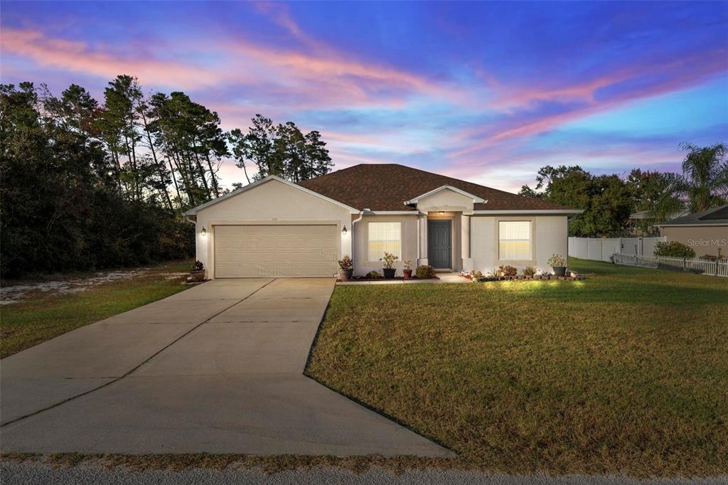 3859 Southwest 109th Lane Ocala, FL 34476 - Photo 55 of 55 a front view of a house with a yard