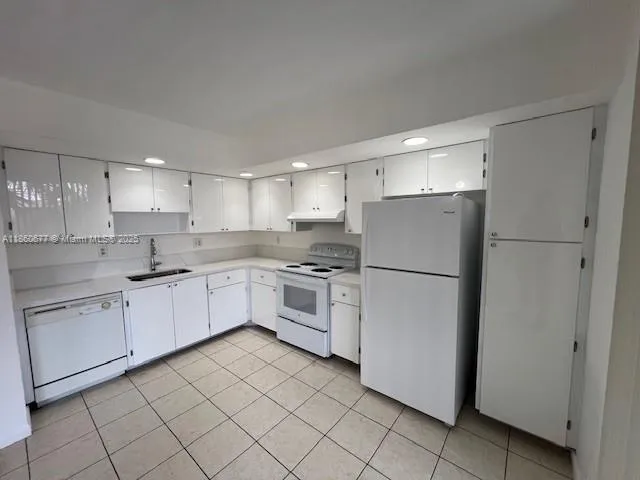 a kitchen with cabinets stainless steel appliances and a counter space