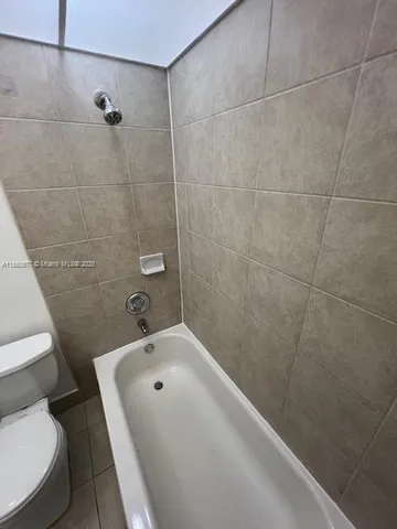 a bathroom with a toilet and shower