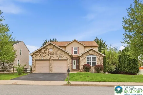 a front view of a house with a yard and garage