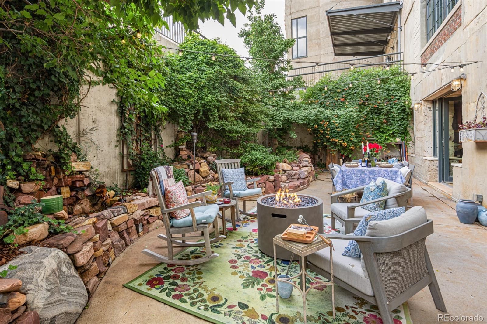 2000 Little Raven Street, Unit 1B Denver, CO 80202 - Photo 38 of 39 a view of a patio with table and chairs and potted plants