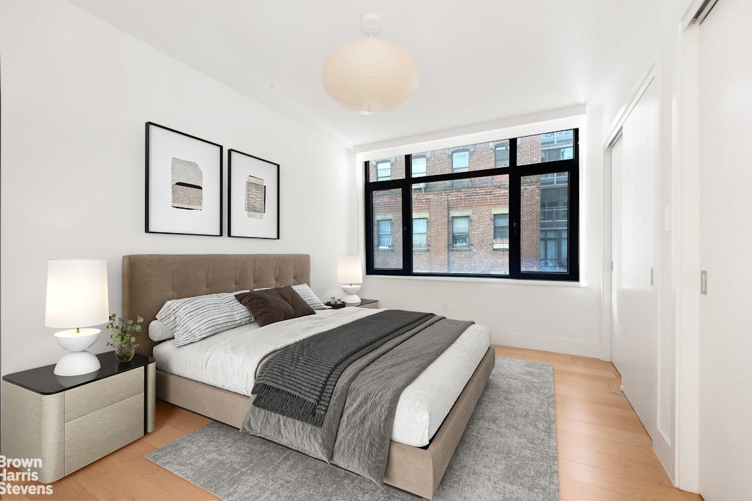 131 Devoe Street, Unit 4C Brooklyn, NY 11211 - Photo 5 of 10 a bedroom with a bed and a large window