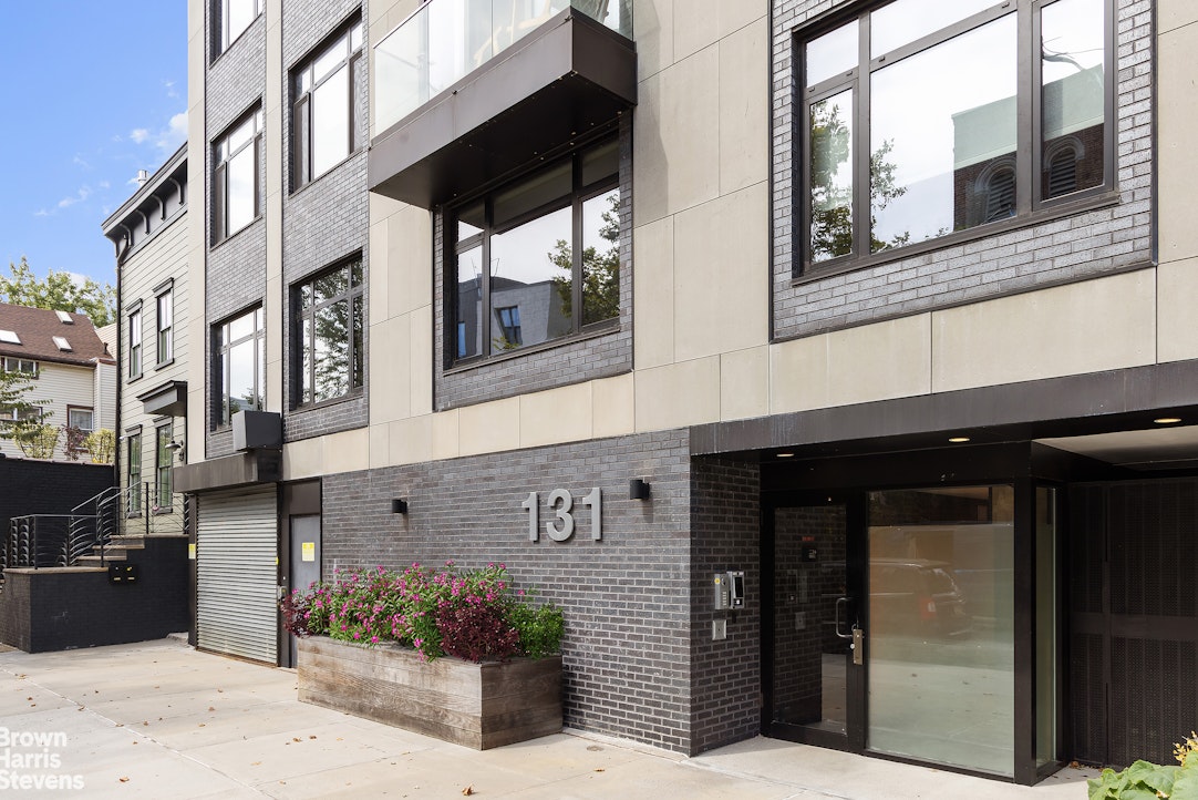 131 Devoe Street, Unit 4C Brooklyn, NY 11211 - Photo 9 of 10 a view of a building with a potted plant windows