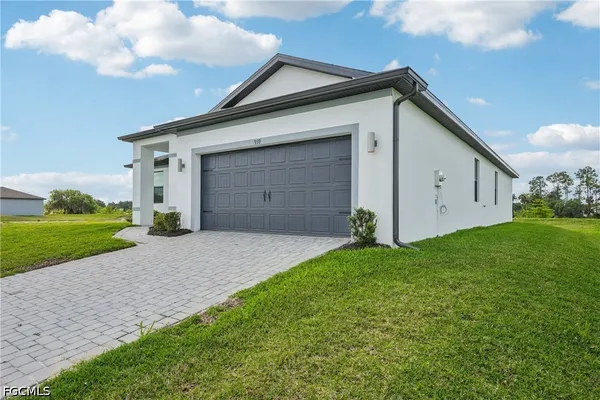 an empty room with wooden floor and window