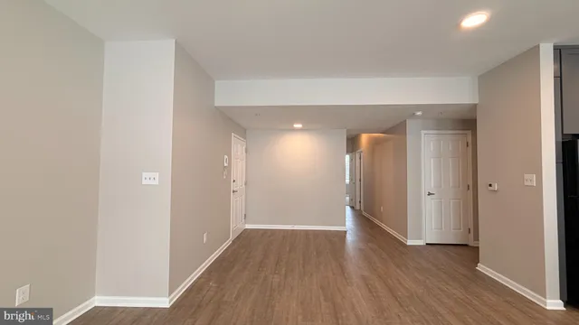 a view of hallway with wooden floor