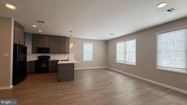 a kitchen with a refrigerator and a stove top oven