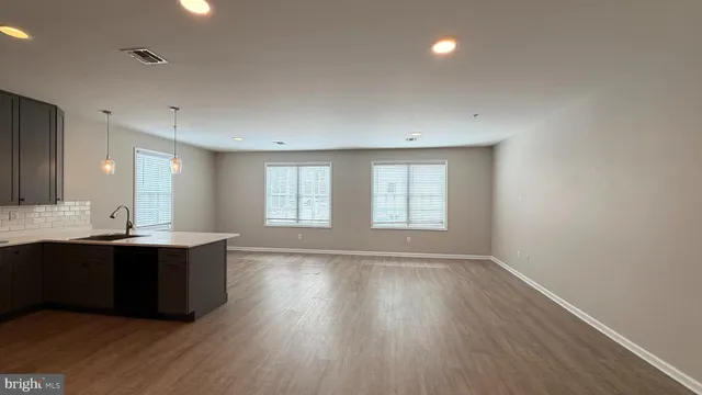 a view of a room with wooden floor and window