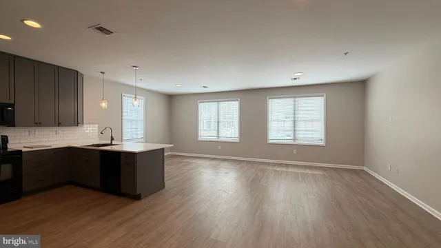 a view of kitchen with sink and wooden floor