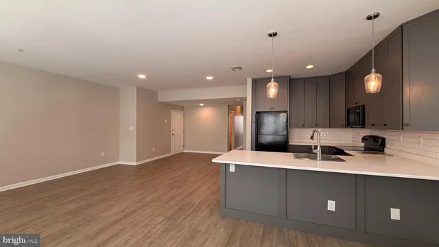 a large kitchen with a sink and a large mirror
