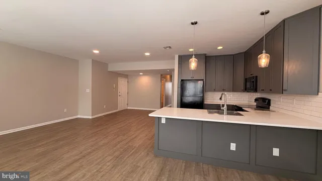 a view of a kitchen with a sink dishwasher a refrigerator and a mirror