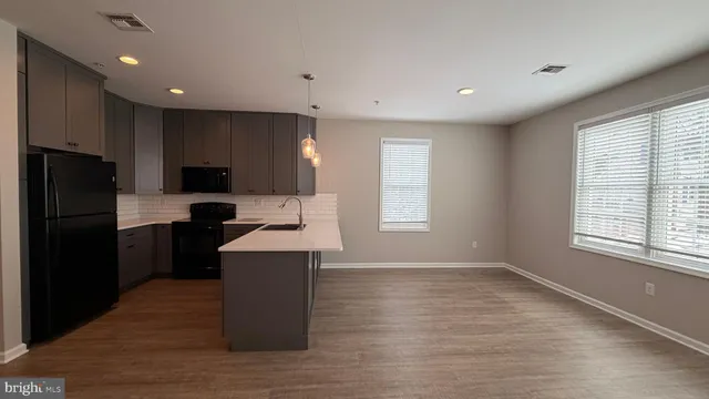 a kitchen with a refrigerator and a sink