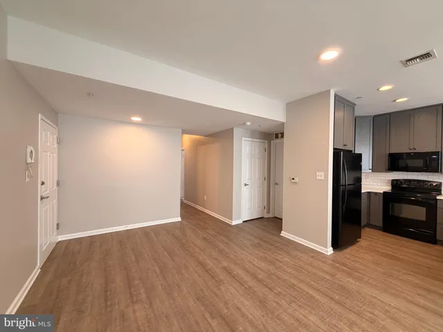 a view of a kitchen with a sink and a refrigerator